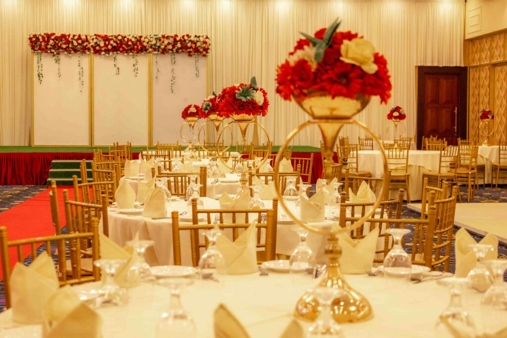 Luxurious wedding reception setup featuring floral centerpieces and elegant decor in banquet hall.