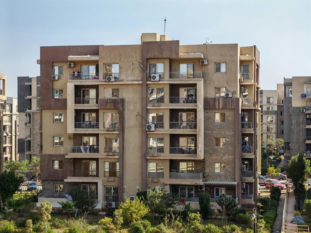A contemporary apartment building with balconies in a cityscape.